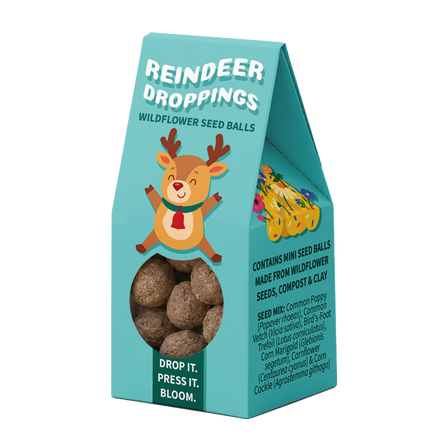 A teal stand-up pouch package labeled 'Reindeer Droppings' with a cartoon reindeer illustration, a clear window showing round seed balls, and product text on a white background.