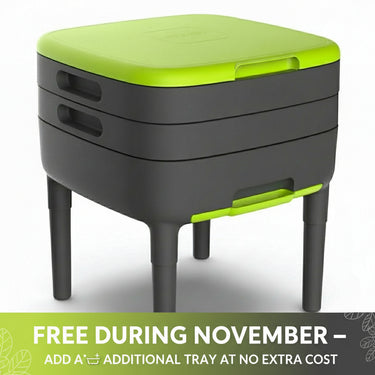 A two-tiered Maze Worm Farm Kit with black legs and a green lid, made from recycled plastic, designed for composting and recycling kitchen waste.